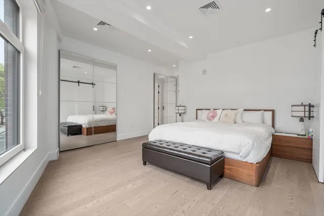 a spacious bedroom with a bed and a large window