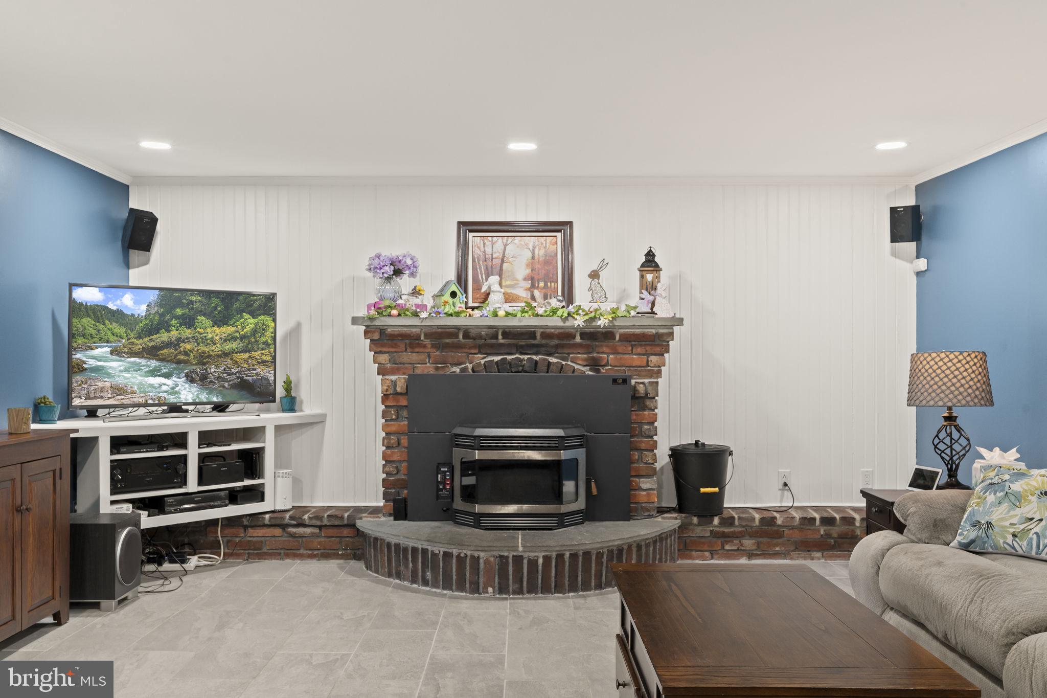 4901 Reedman Avenue Bensalem, PA 19020 - Photo 10 of 55 a living room with furniture a flat screen tv and a fireplace