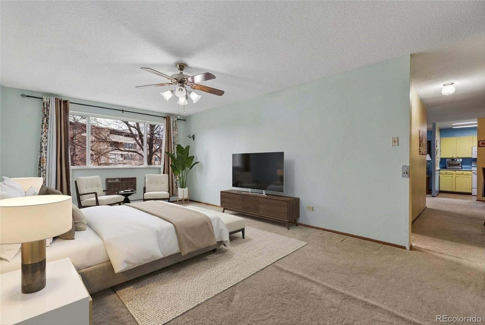 9155 Center Avenue, Unit 3B Denver, CO 80247 - Photo 12 of 50 a bedroom with a bed and a chandelier