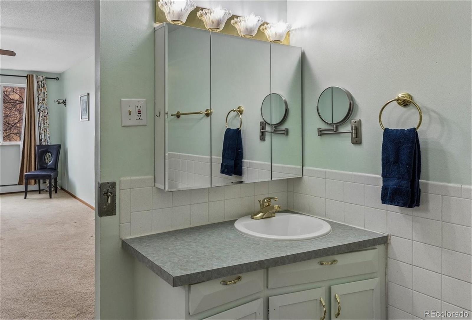 9155 Center Avenue, Unit 3B Denver, CO 80247 - Photo 15 of 50 a bathroom with a sink and a mirror