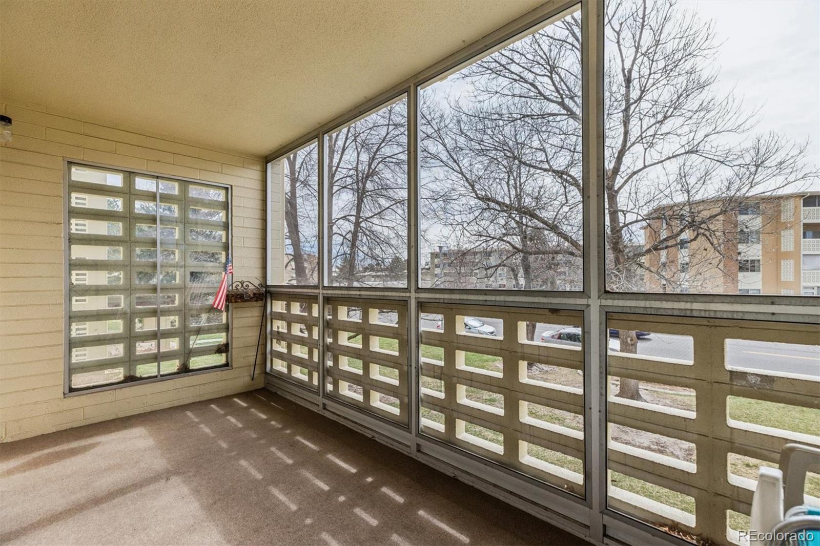 9155 Center Avenue, Unit 3B Denver, CO 80247 - Photo 18 of 50 a view of a porch with a wooden fence and trees