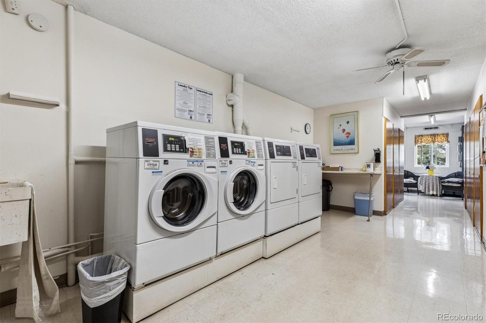 9155 Center Avenue, Unit 3B Denver, CO 80247 - Photo 19 of 50 a utility room with dryer washer and a view of living room
