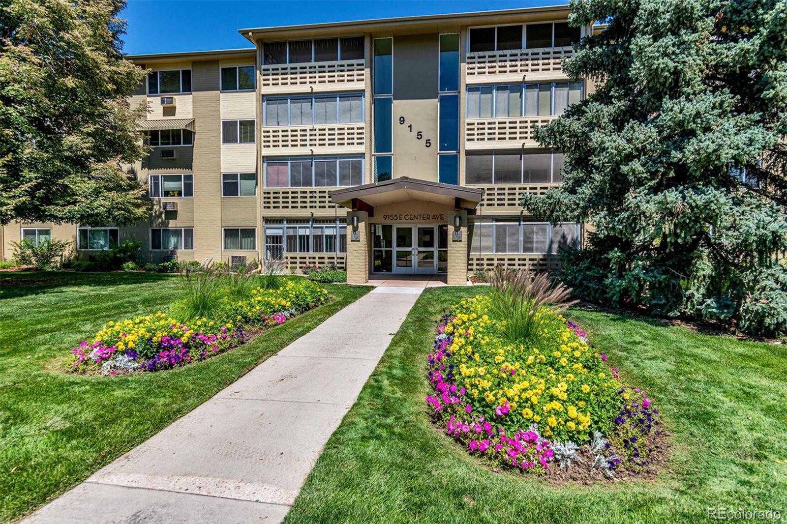 9155 Center Avenue, Unit 3B Denver, CO 80247 - Photo 22 of 50 a front view of a multi story building with yard