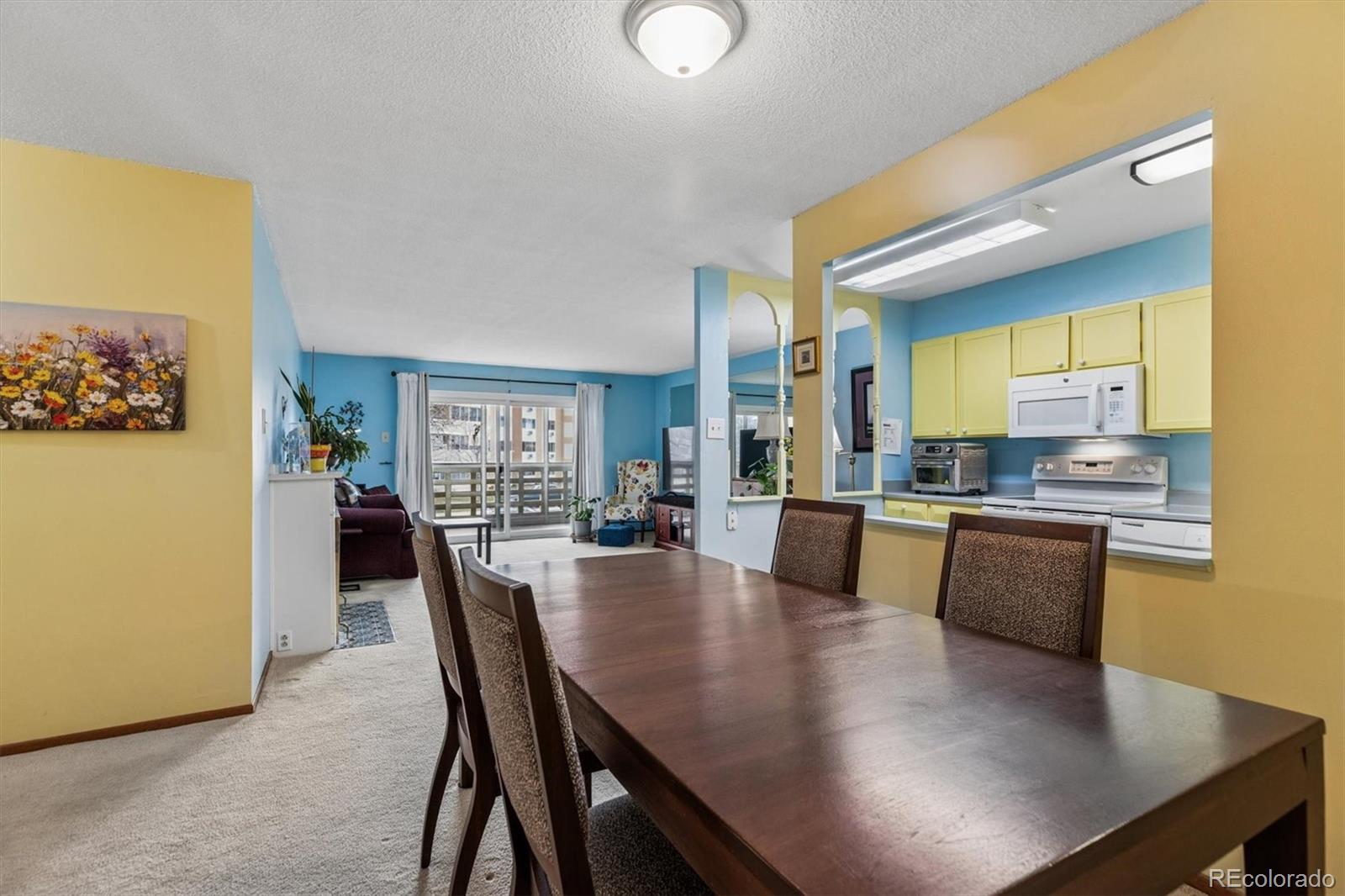 9155 Center Avenue, Unit 3B Denver, CO 80247 - Photo 3 of 50 a view of a dining room with furniture and wooden floor