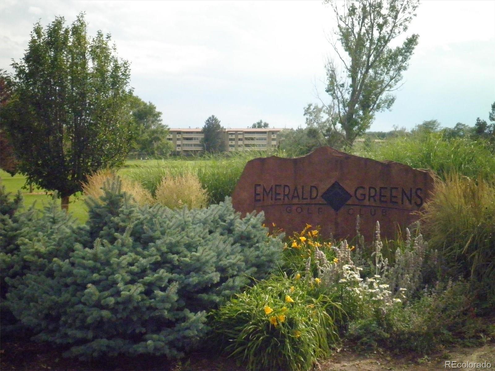 9155 Center Avenue, Unit 3B Denver, CO 80247 - Photo 38 of 50 a view of a house with a yard and a pond