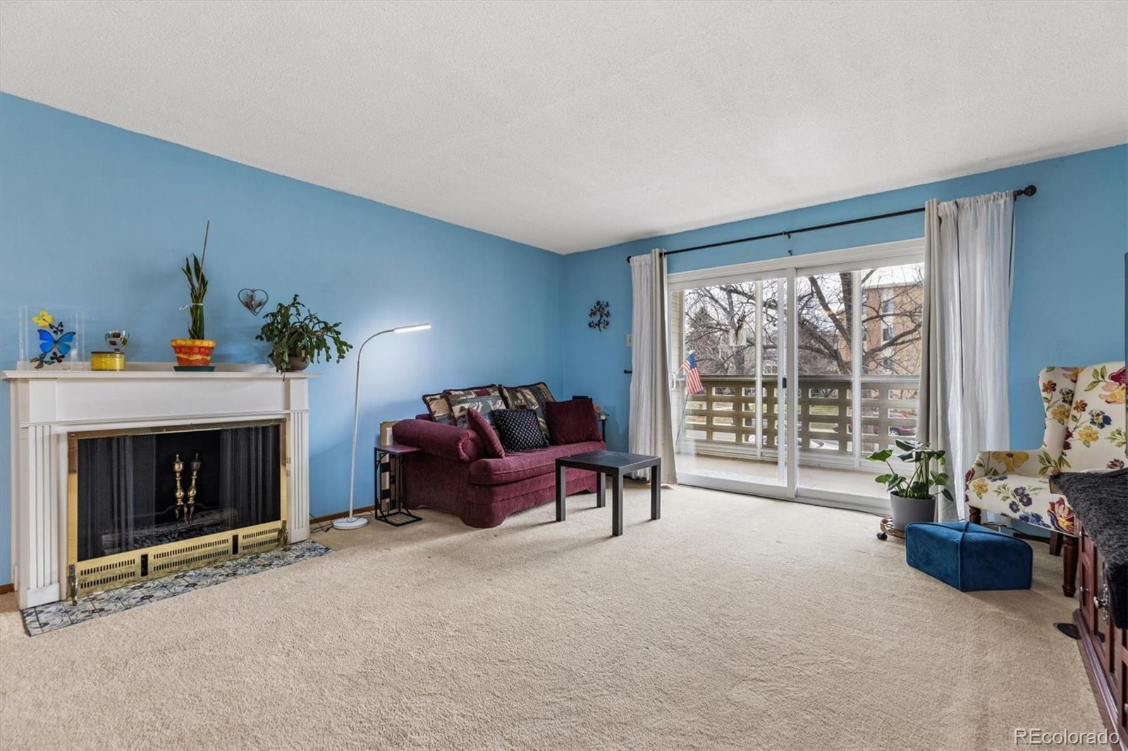 9155 Center Avenue, Unit 3B Denver, CO 80247 - Photo 7 of 50 a living room with furniture and a fireplace