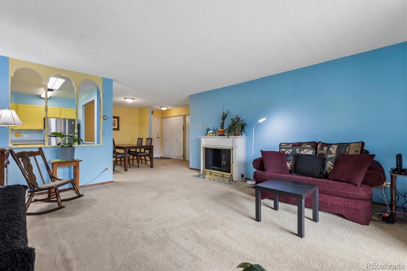 9155 Center Avenue, Unit 3B Denver, CO 80247 - Photo 8 of 50 a living room with furniture and a fireplace
