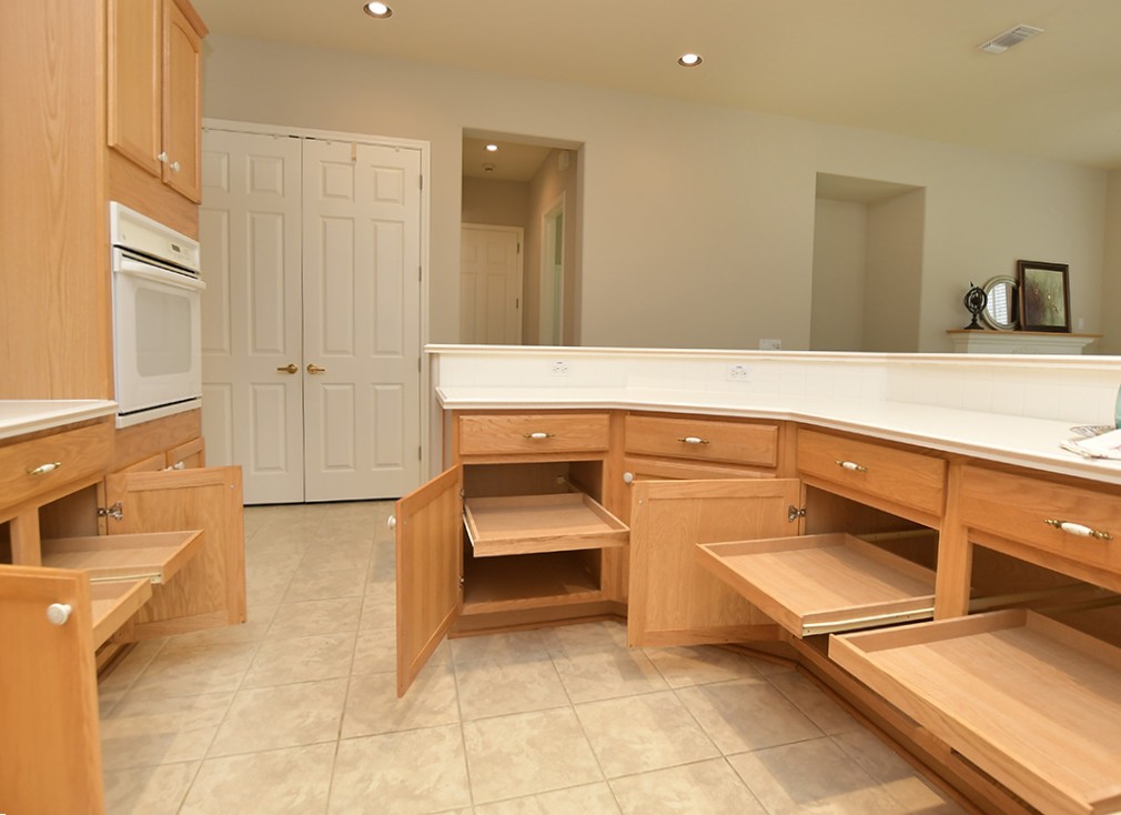 120 Golf View Drive Georgetown, TX 78633 - Photo 11 of 32 Much appreciated pull-out shelves are found in most lower cabinets in the kitchen.