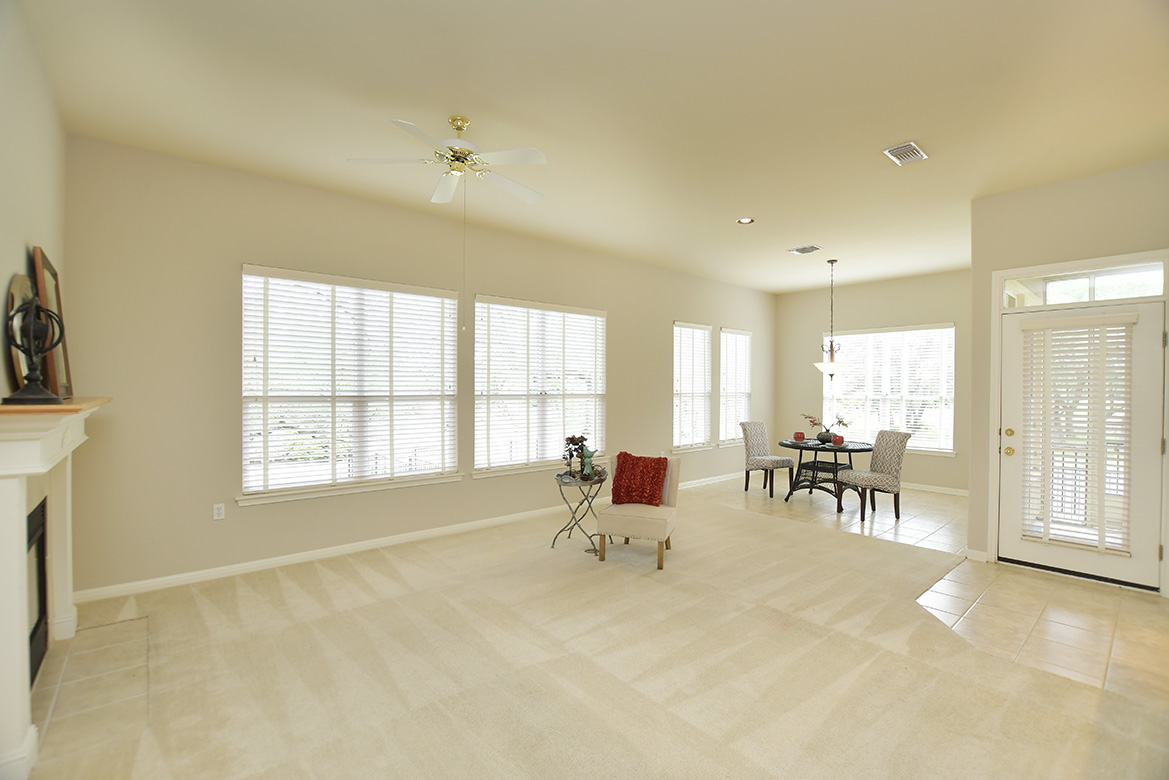 120 Golf View Drive Georgetown, TX 78633 - Photo 15 of 32 A wall of windows adds natural light to the family room and breakfast nook, offering golf course views.