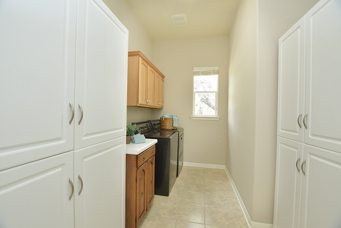 120 Golf View Drive Georgetown, TX 78633 - Photo 18 of 32 Across from the powder room near the kitchen/family room is a laundry room with generous upper cabinets.