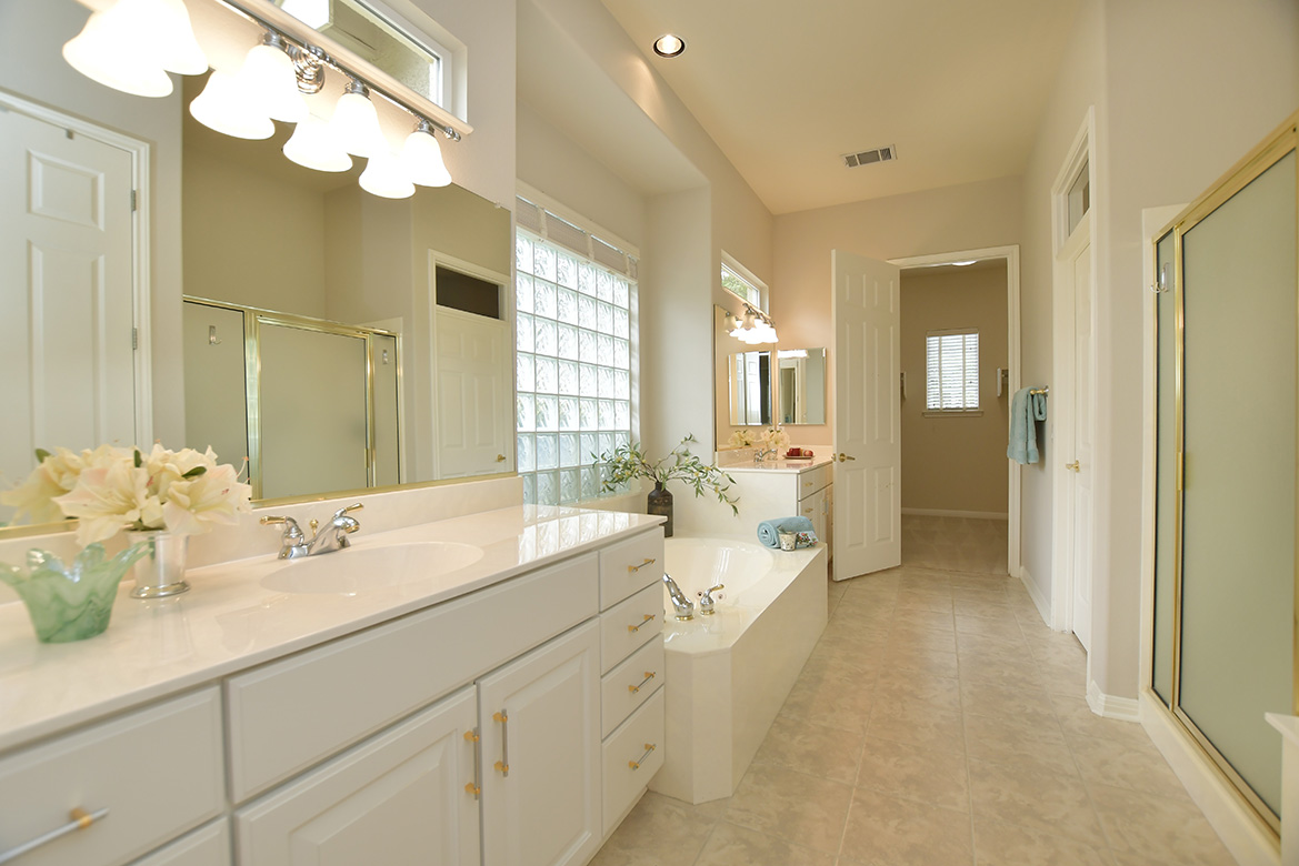 120 Golf View Drive Georgetown, TX 78633 - Photo 21 of 32 Vanities are nicely separated by a jetted tub in the primary bath. A standalone shower offers choices at the beginning or end of the day.