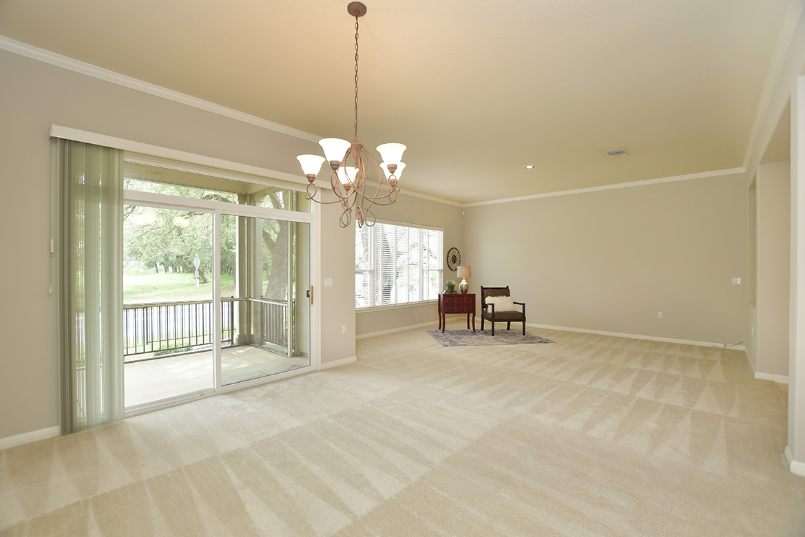 120 Golf View Drive Georgetown, TX 78633 - Photo 6 of 32 Living/dining area offers access to the back patio through full-view sliding door.