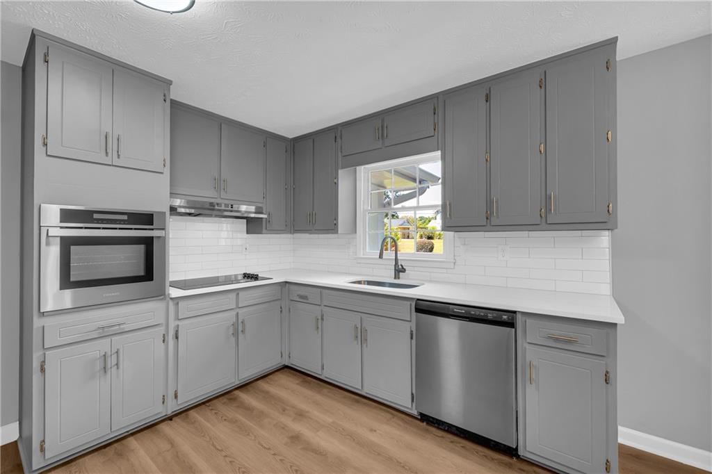 4872 Arrowhead Trail W Southwest Lilburn, GA 30047 - Photo 11 of 44 a kitchen with a sink cabinets and window