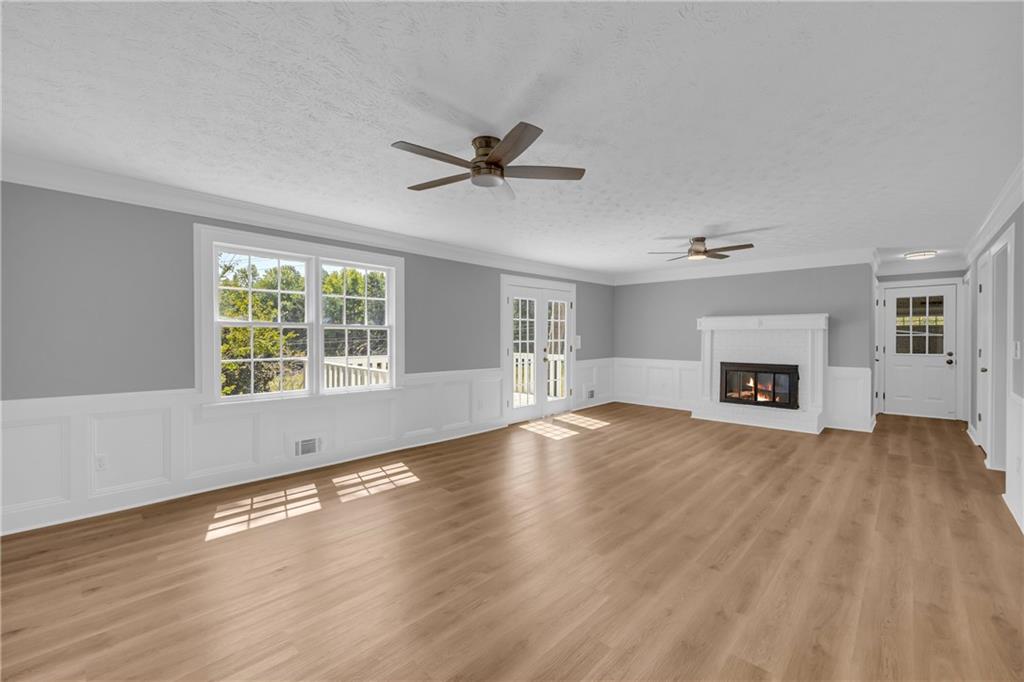 4872 Arrowhead Trail W Southwest Lilburn, GA 30047 - Photo 12 of 44 a view of empty room with wooden floor and fireplace