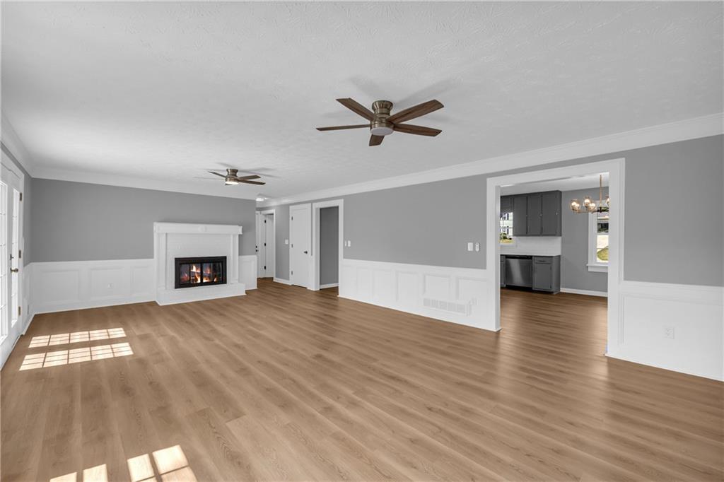 4872 Arrowhead Trail W Southwest Lilburn, GA 30047 - Photo 13 of 44 a view of empty room with wooden floor and fireplace
