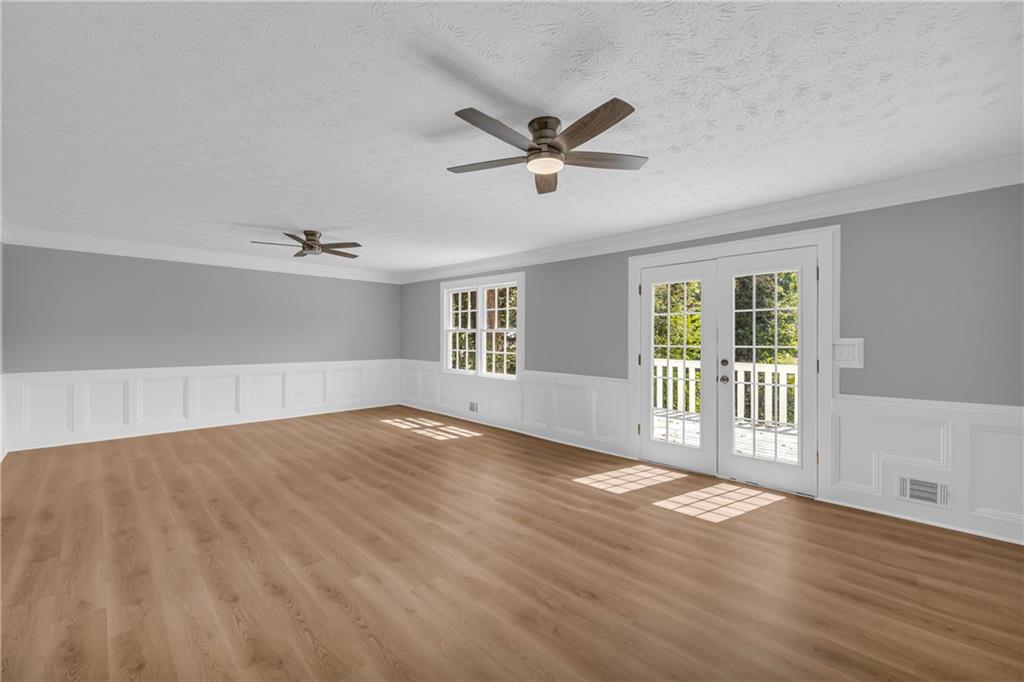 4872 Arrowhead Trail W Southwest Lilburn, GA 30047 - Photo 14 of 44 a view of an empty room with wooden floor and a window