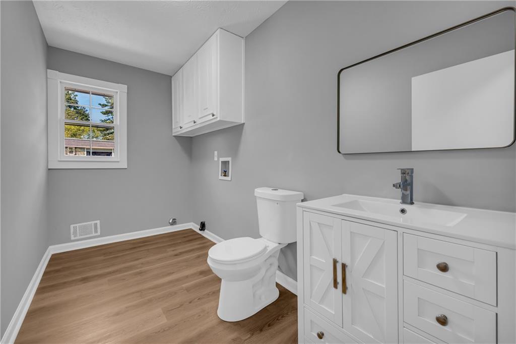 4872 Arrowhead Trail W Southwest Lilburn, GA 30047 - Photo 19 of 44 a bathroom with a sink and a toilet