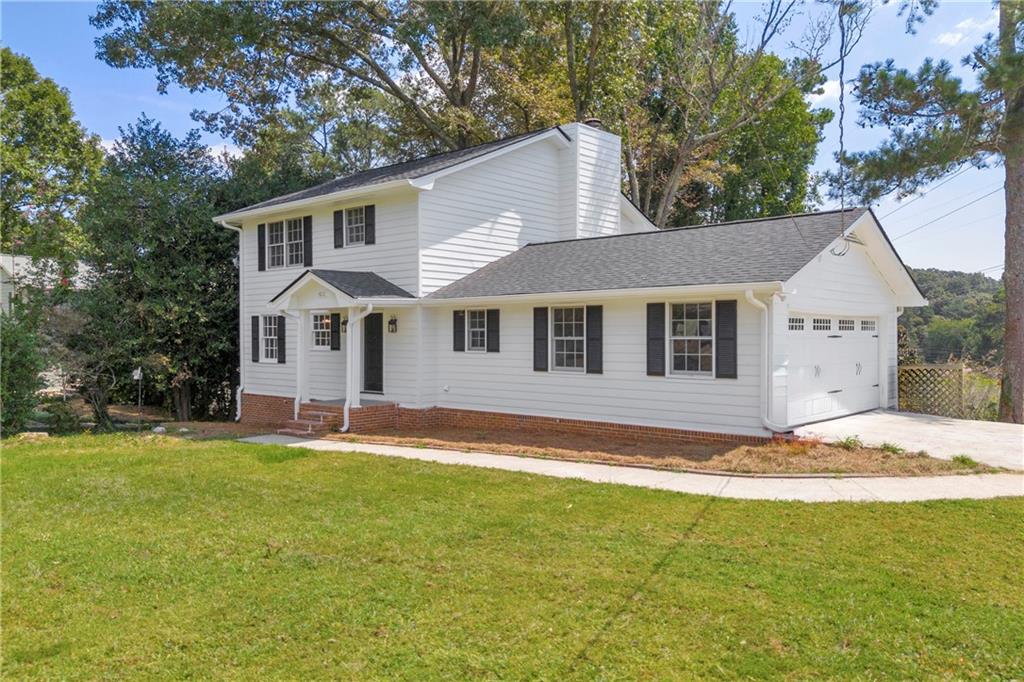 4872 Arrowhead Trail W Southwest Lilburn, GA 30047 - Photo 2 of 44 a front view of a house with a yard