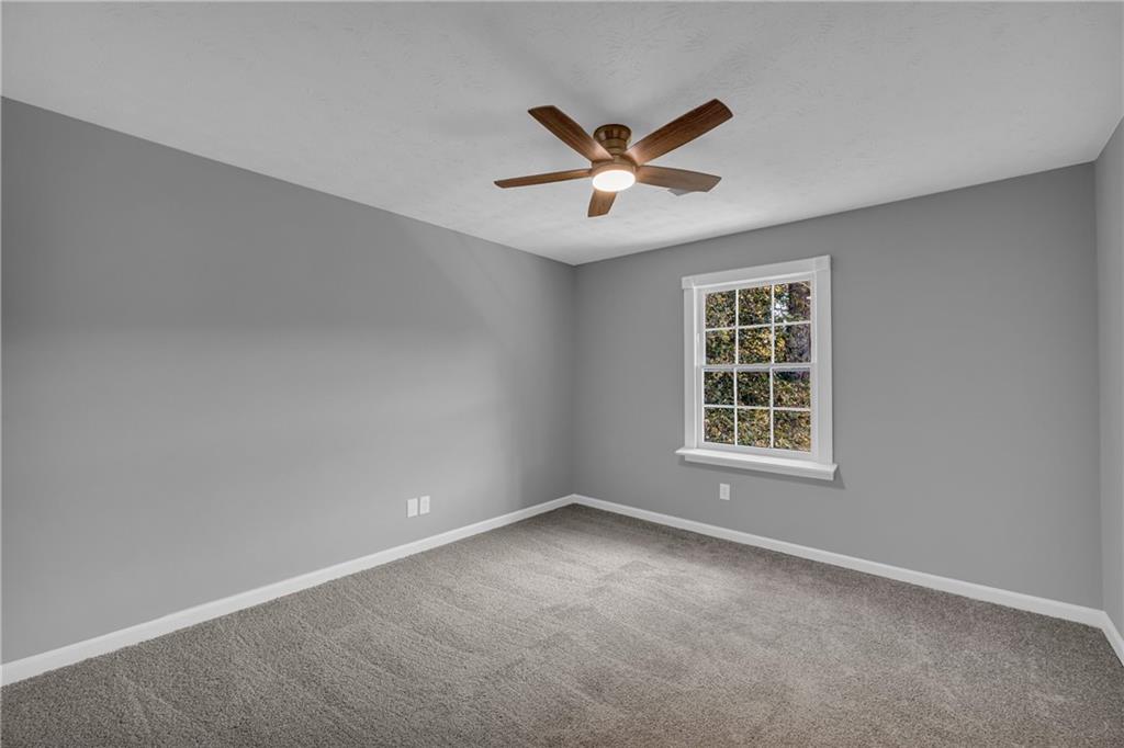 4872 Arrowhead Trail W Southwest Lilburn, GA 30047 - Photo 24 of 44 an empty room with a window and ceiling fan