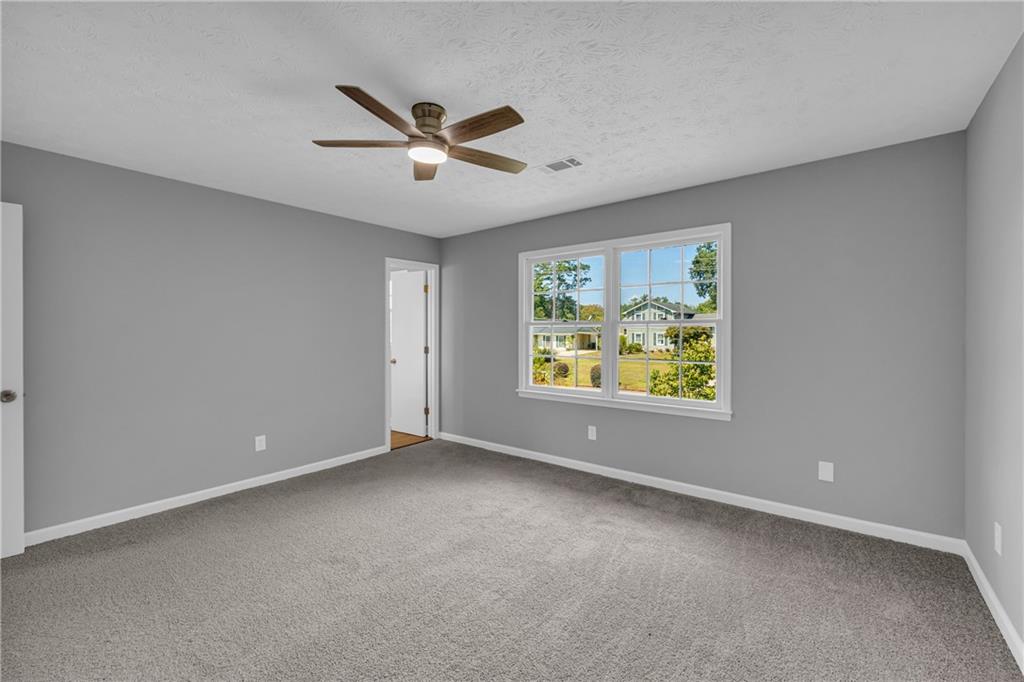4872 Arrowhead Trail W Southwest Lilburn, GA 30047 - Photo 27 of 44 a view of an empty room with window