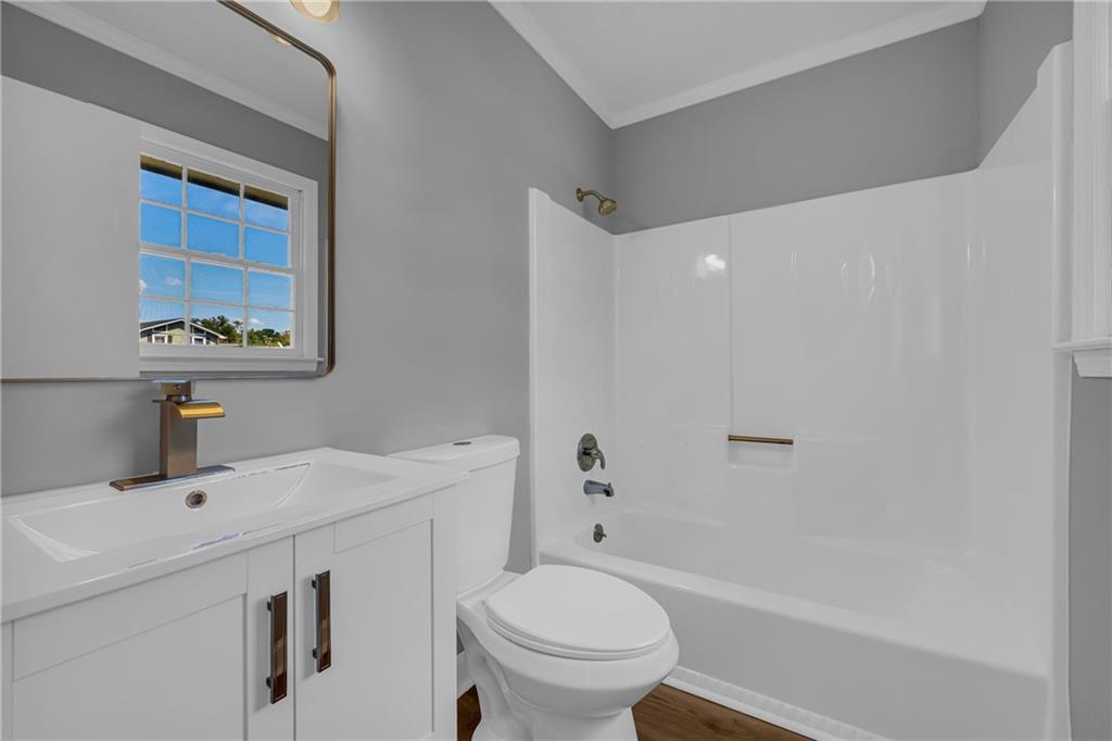 4872 Arrowhead Trail W Southwest Lilburn, GA 30047 - Photo 29 of 44 a bathroom with a sink toilet vanity and tub
