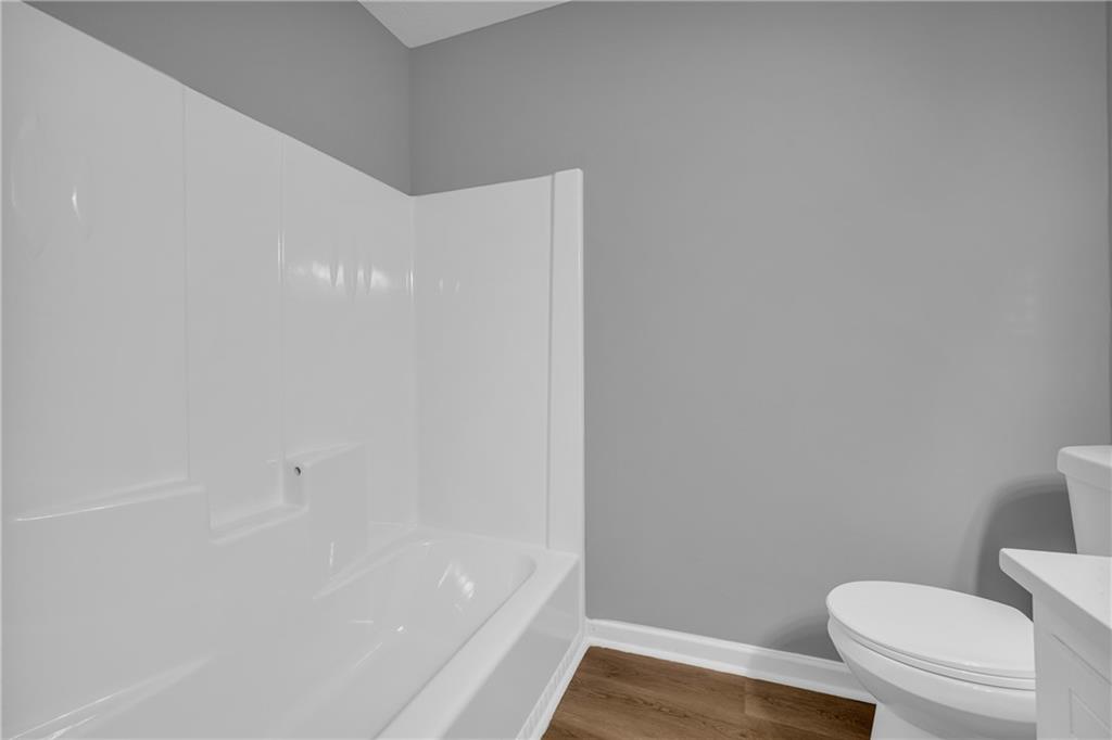 4872 Arrowhead Trail W Southwest Lilburn, GA 30047 - Photo 30 of 44 a bathroom with a toilet and a bathtub