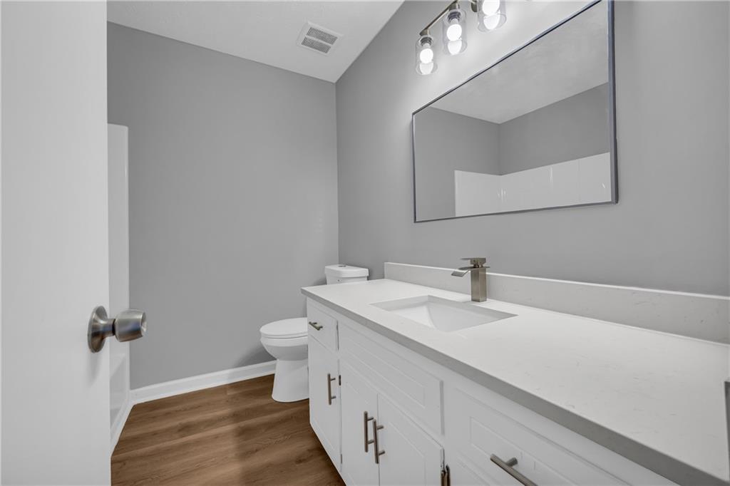 4872 Arrowhead Trail W Southwest Lilburn, GA 30047 - Photo 31 of 44 a bathroom with a sink and a mirror