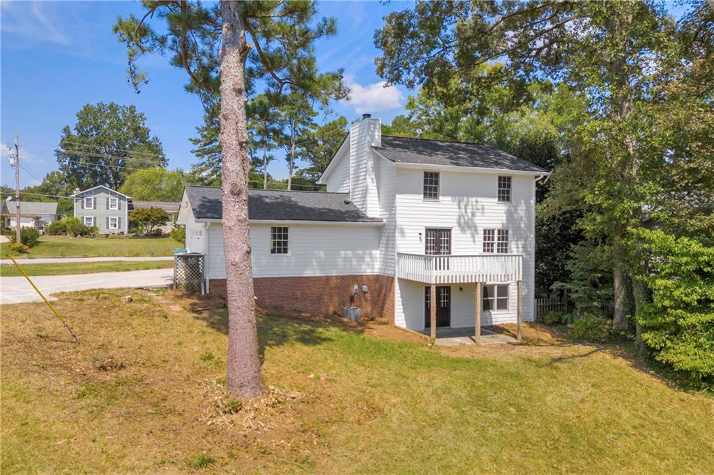 4872 Arrowhead Trail W Southwest Lilburn, GA 30047 - Photo 37 of 44 a front view of a house with a yard