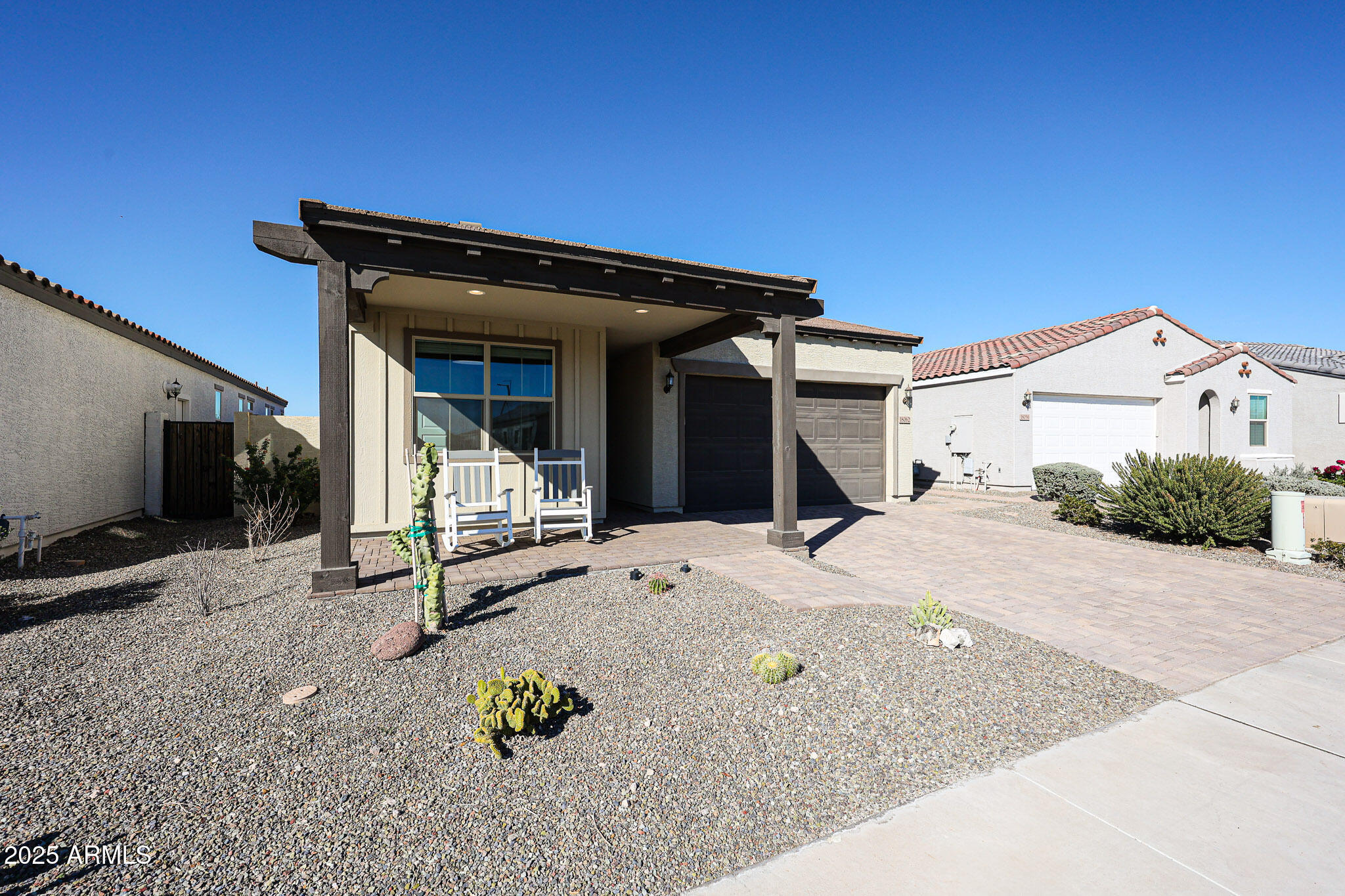 a view of a house with backyard and sitting area