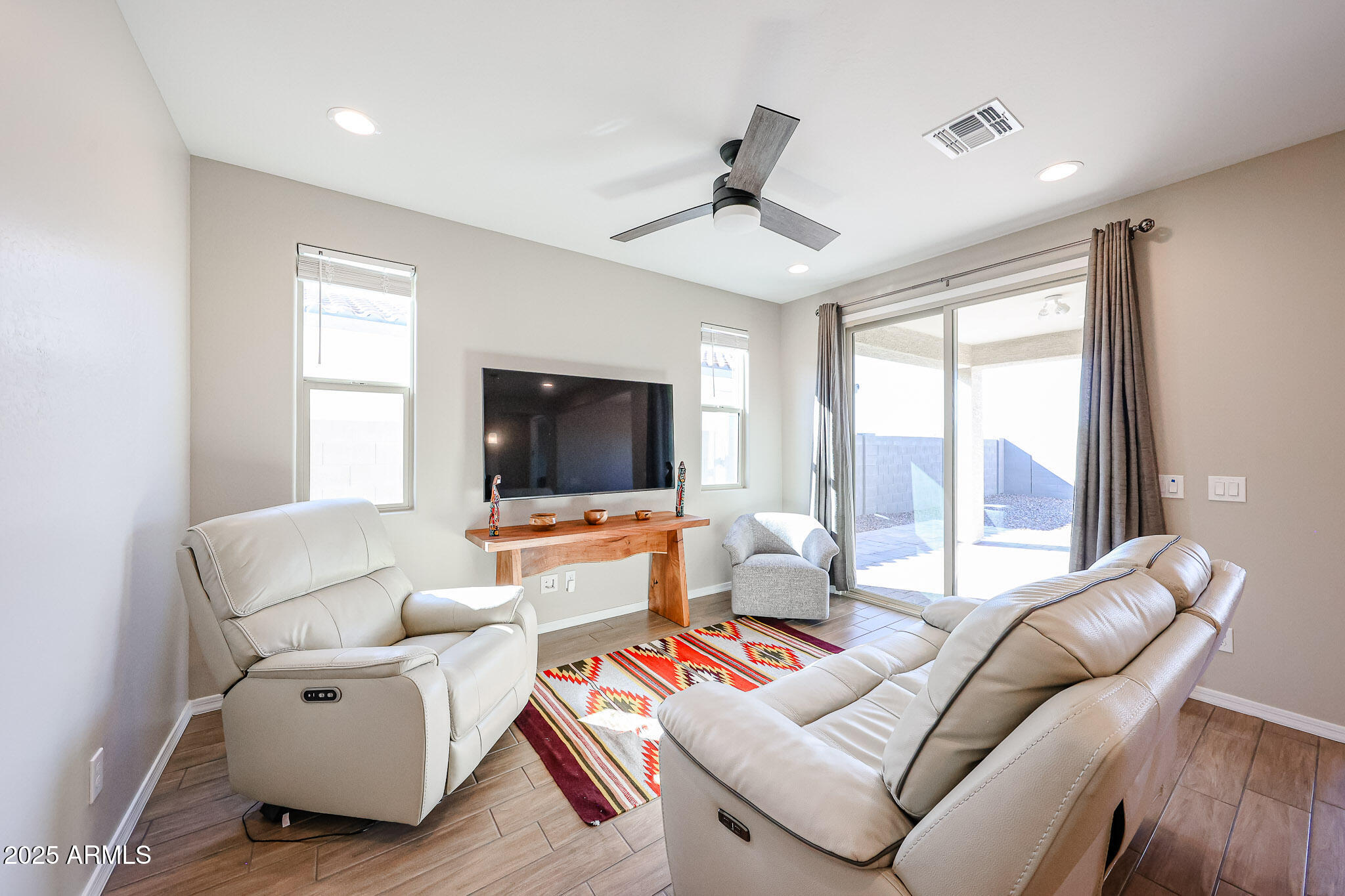 18062 West Amber Ridge Way Goodyear, AZ 85338 - Photo 12 of 67 a living room with furniture and a flat screen tv