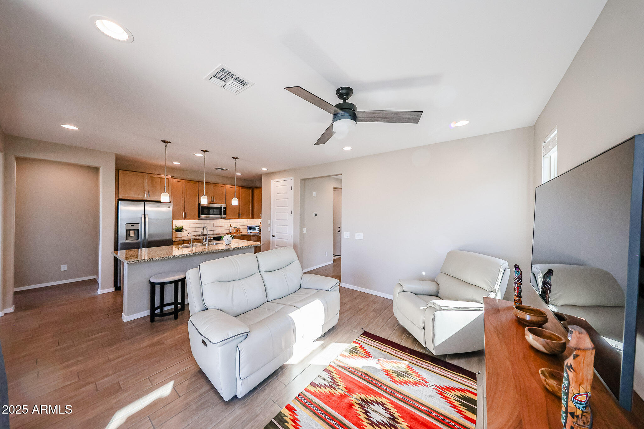 18062 West Amber Ridge Way Goodyear, AZ 85338 - Photo 13 of 67 a living room with furniture and a wooden floor