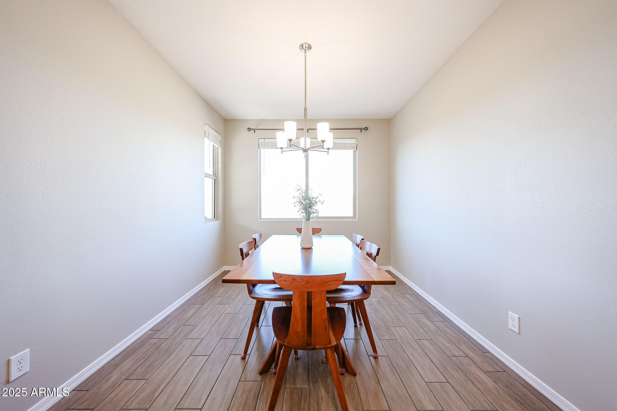 18062 West Amber Ridge Way Goodyear, AZ 85338 - Photo 15 of 67 a view of a dining room with furniture window and wooden floor