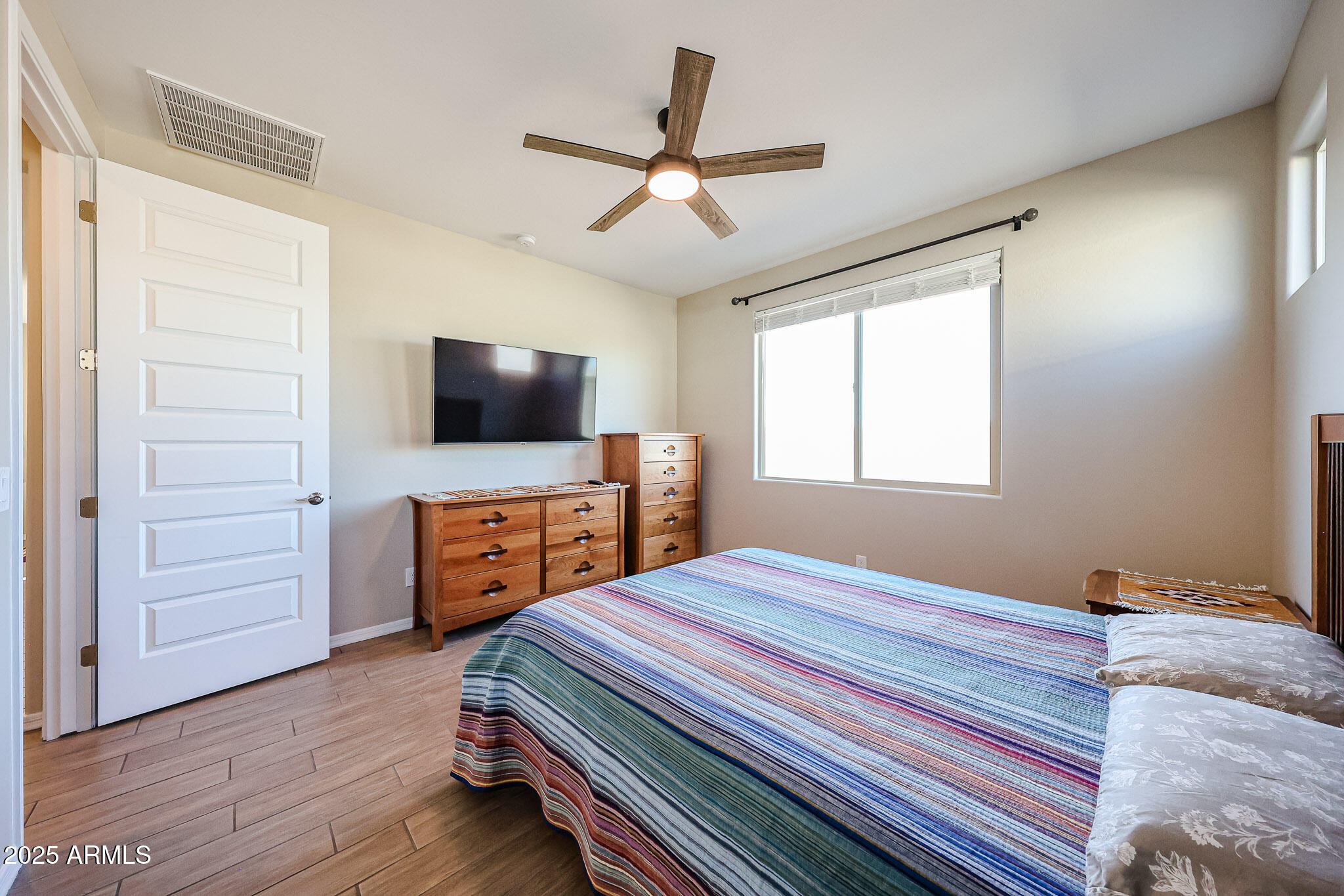 18062 West Amber Ridge Way Goodyear, AZ 85338 - Photo 19 of 67 a bedroom with a bed and a flat screen tv
