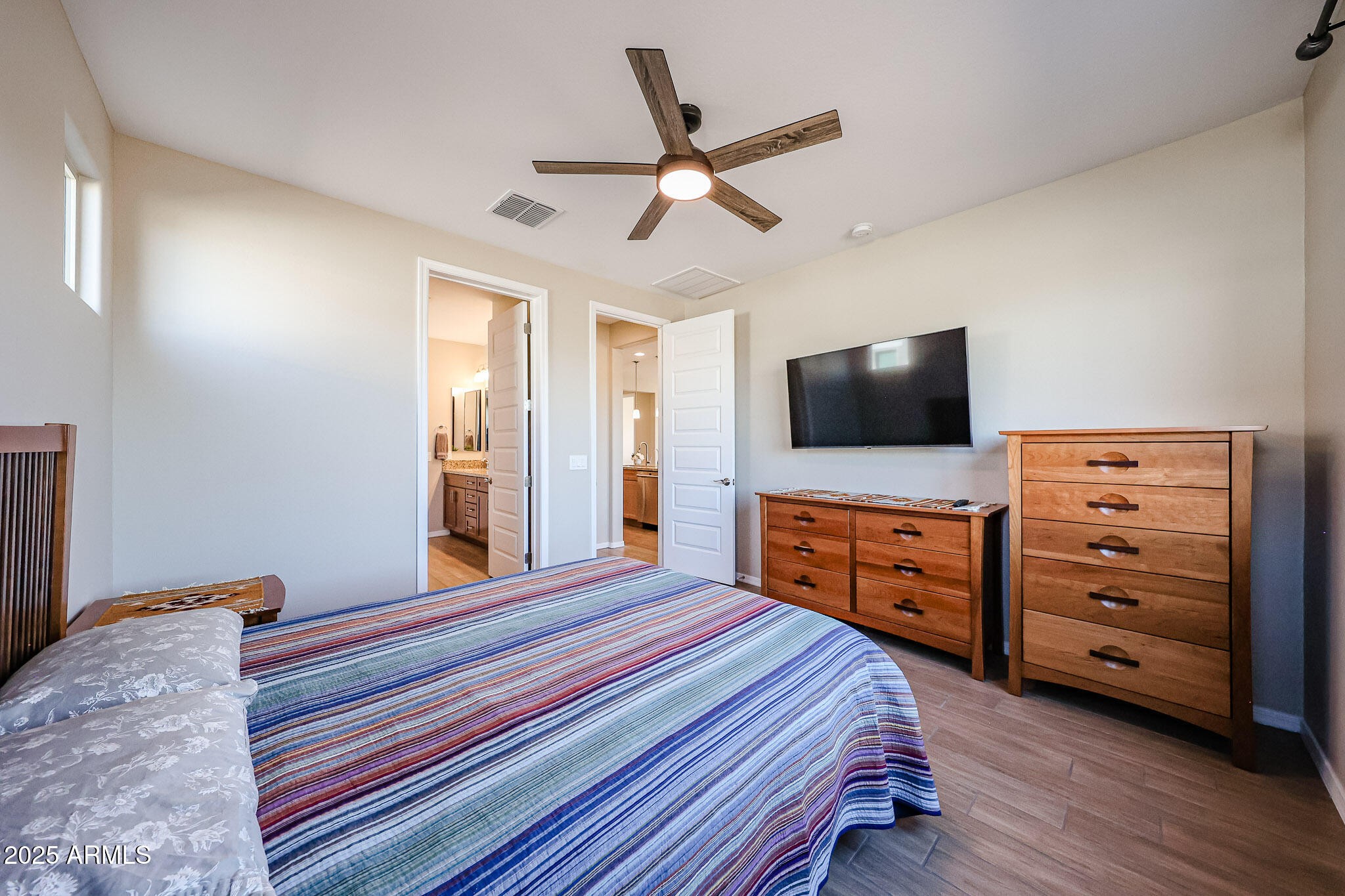 18062 West Amber Ridge Way Goodyear, AZ 85338 - Photo 20 of 67 a bedroom with a bed and flat screen tv