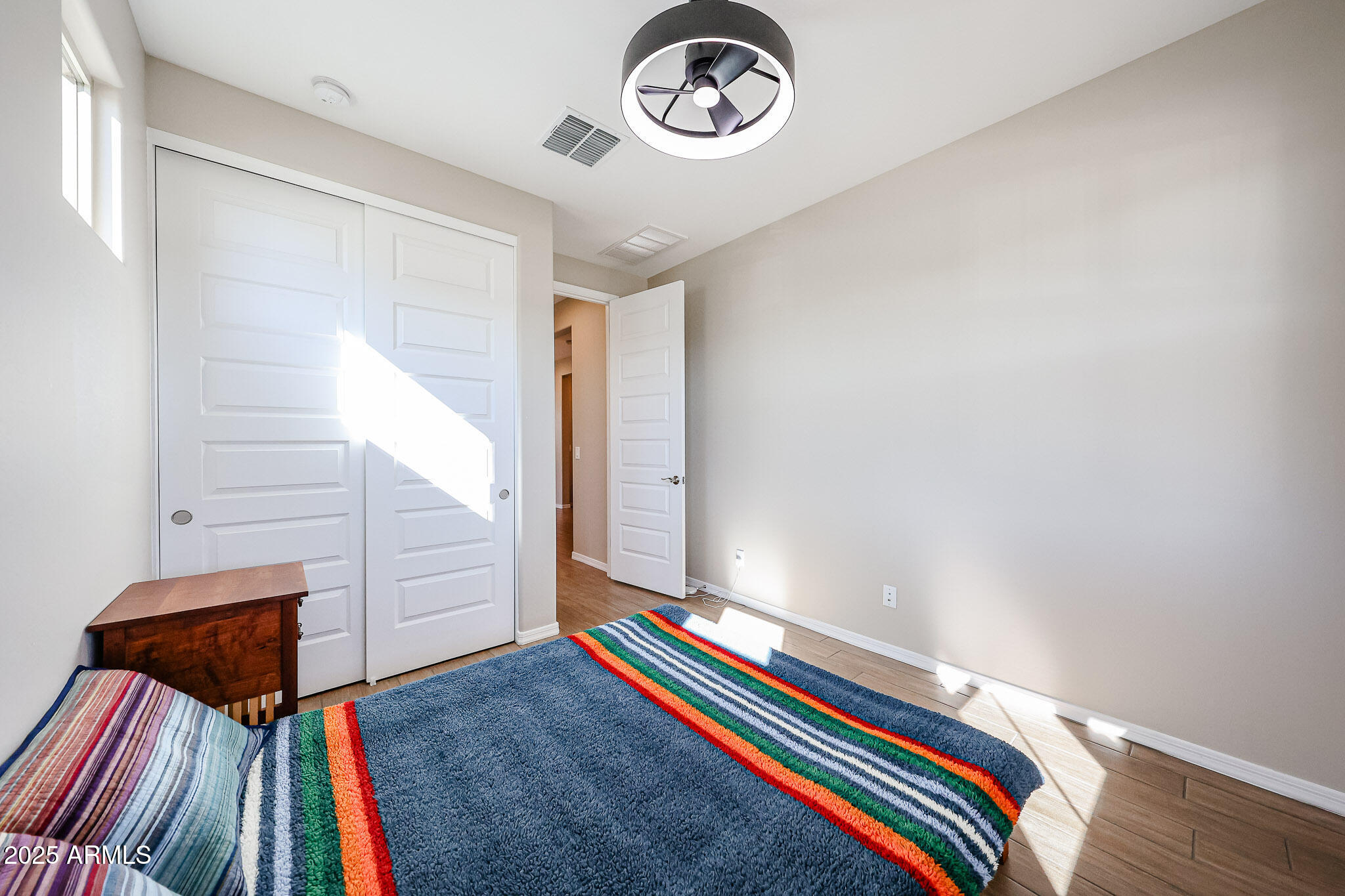 18062 West Amber Ridge Way Goodyear, AZ 85338 - Photo 27 of 67 a room with a bed and a chandelier