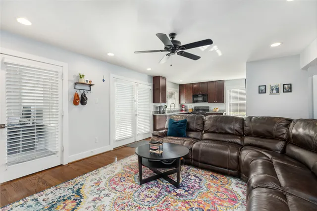 a living room with furniture and a wooden floor