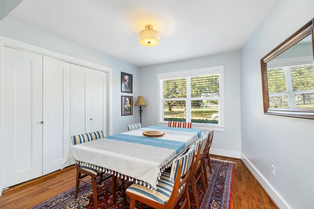 a view of a dining room with furniture and a window