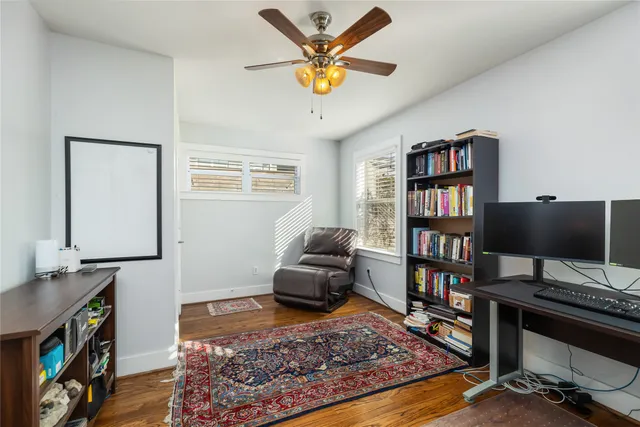 a living room with furniture and a book shelf