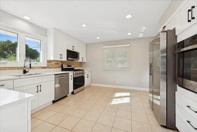 a kitchen with cabinets stainless steel appliances and a counter top space