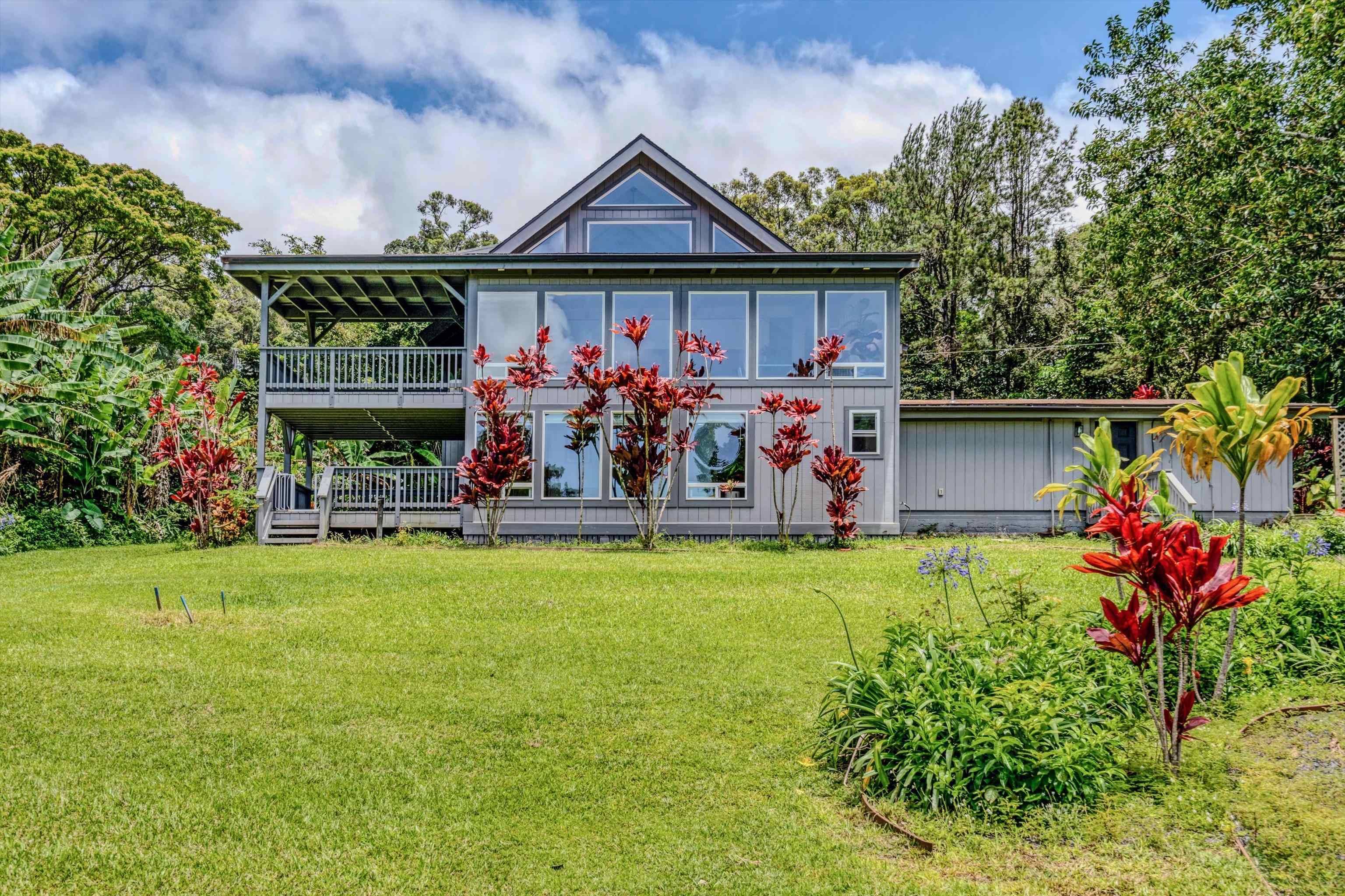 a front view of a house with garden