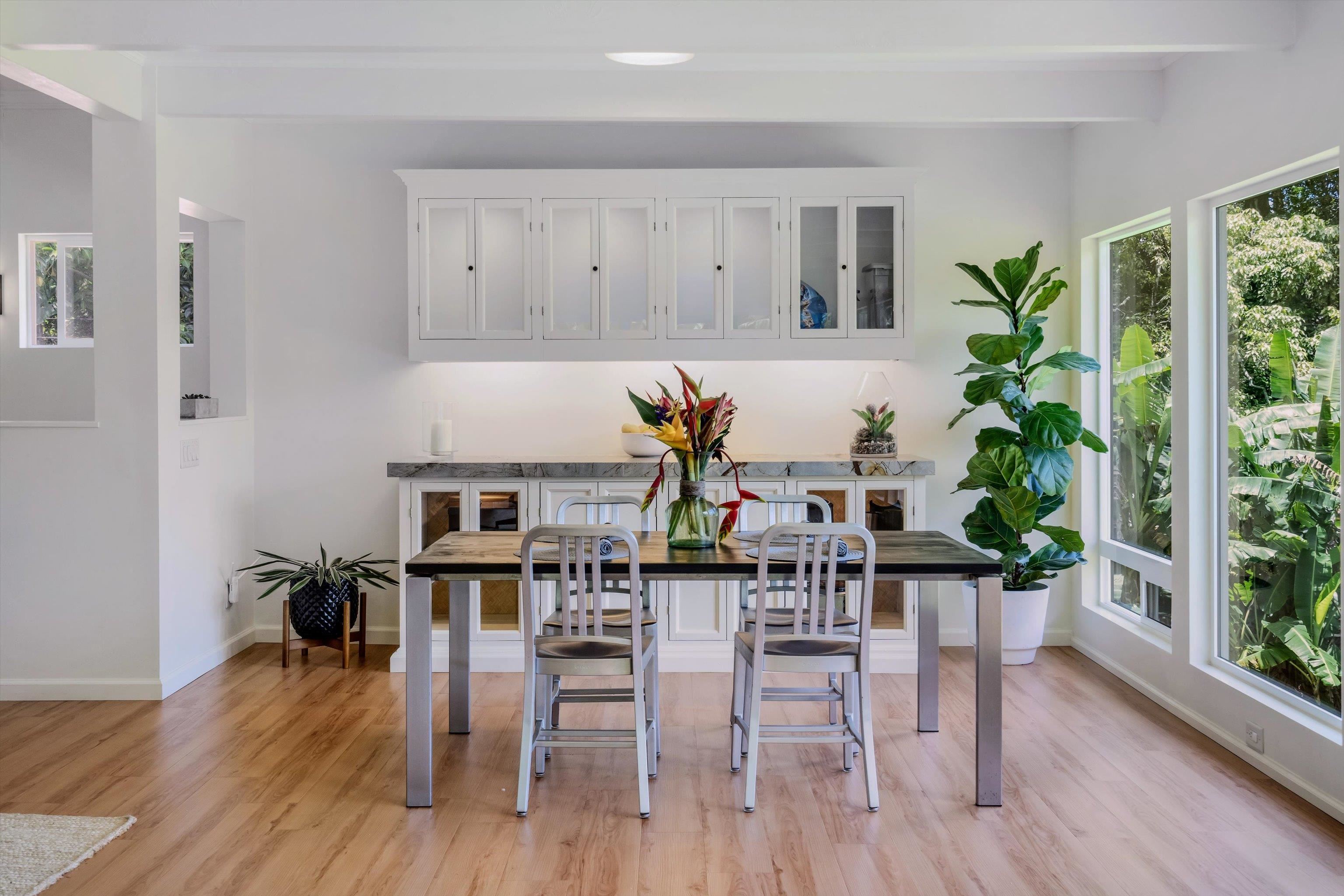 303 Waipalani Road Haiku, HI 96708 - Photo 11 of 46 a dining room with furniture potted plants and wooden floor