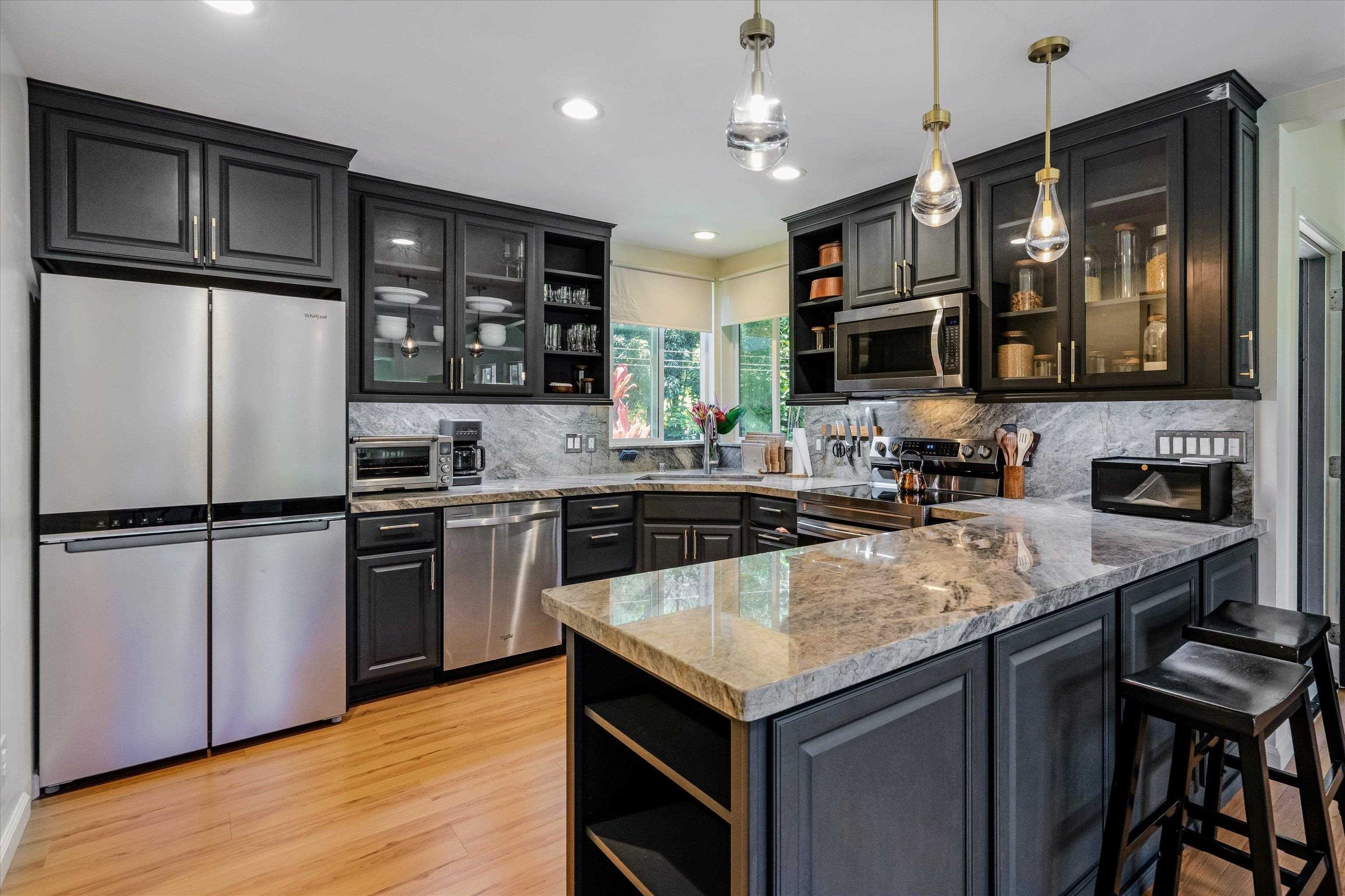 303 Waipalani Road Haiku, HI 96708 - Photo 18 of 46 a kitchen with a refrigerator a stove a sink and a microwave