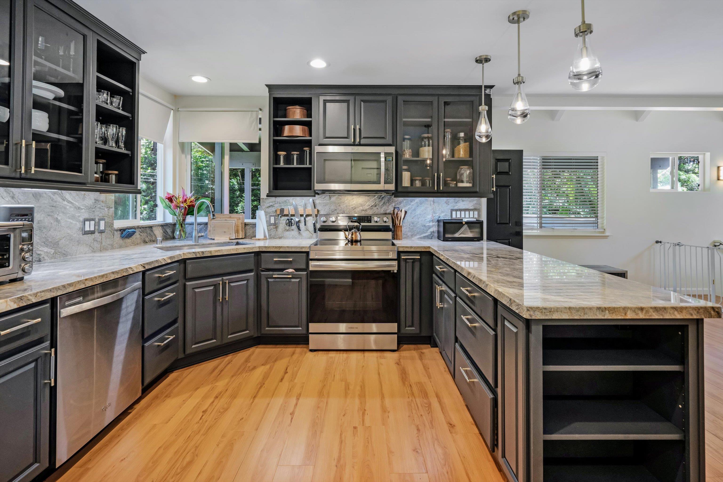 303 Waipalani Road Haiku, HI 96708 - Photo 19 of 46 a kitchen with a sink stove top oven and cabinets
