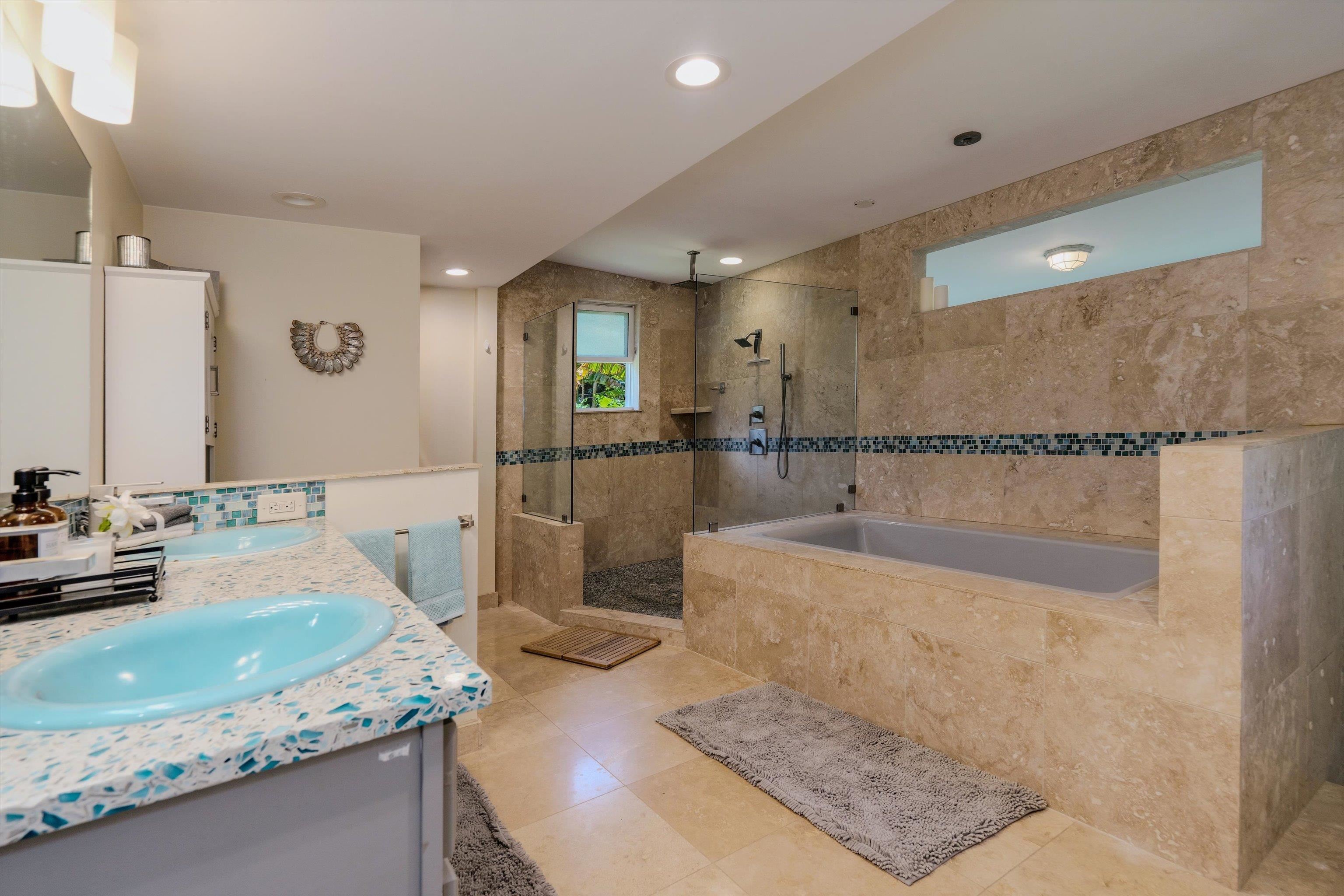 303 Waipalani Road Haiku, HI 96708 - Photo 20 of 46 a bathroom with a granite countertop sink a mirror and bathtub