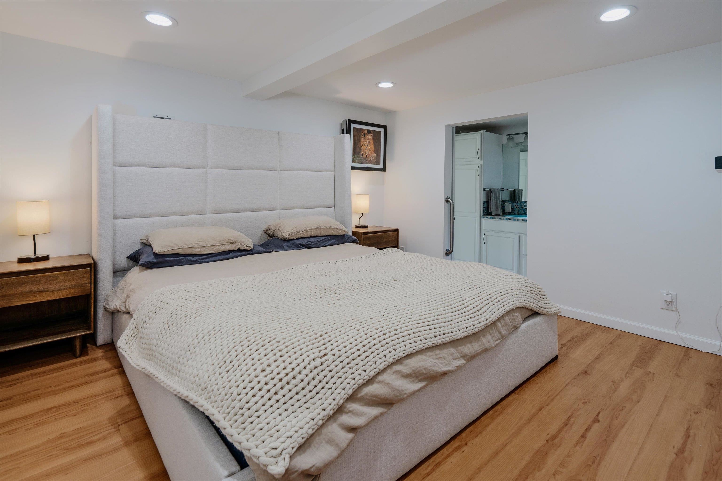 303 Waipalani Road Haiku, HI 96708 - Photo 29 of 46 a bedroom with a bed and wooden floor