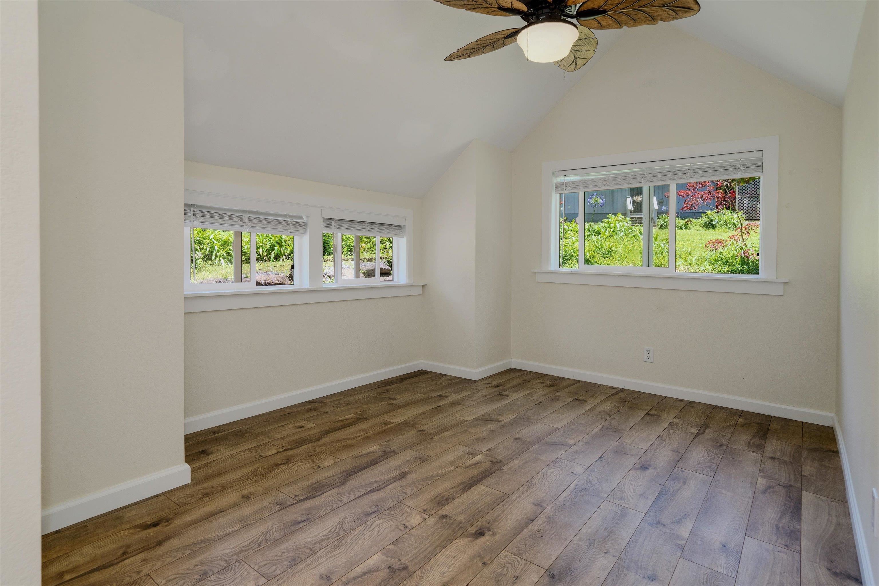 303 Waipalani Road Haiku, HI 96708 - Photo 39 of 46 an empty room with wooden floor and windows
