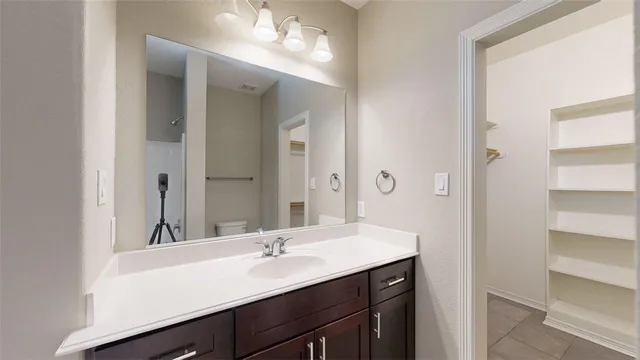 a bathroom with a sink double vanity and a mirror