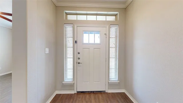 a view of an entryway with wooden floor