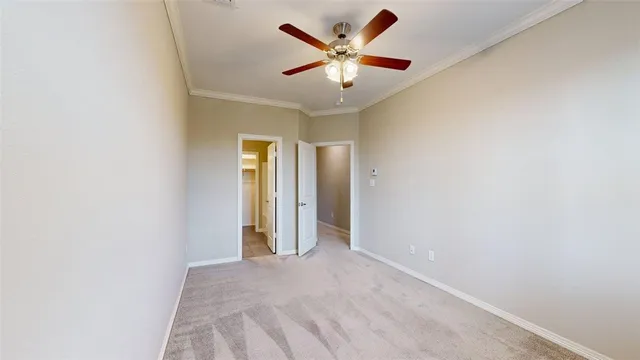 an empty room with a ceiling fan and a window