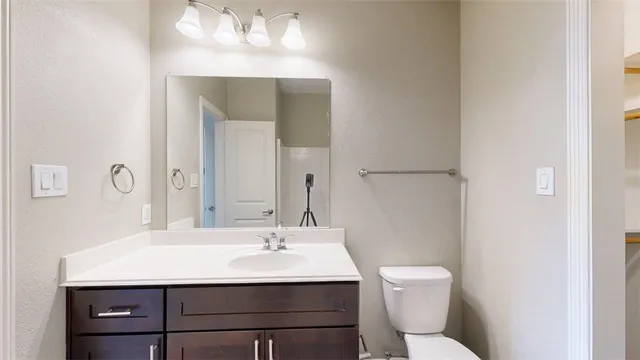 a bathroom with a sink toilet and mirror